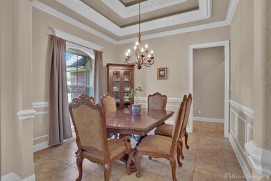 Tiled dining space featuring a notable chandelier,