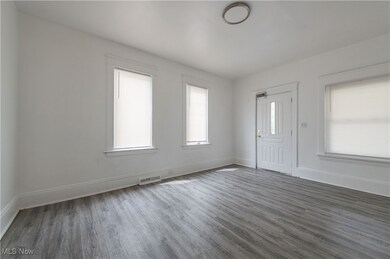 Foyer entrance with dark wood-type flooring and healthy amount of natural light