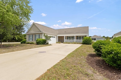 View of front of house with concrete driveway, a g