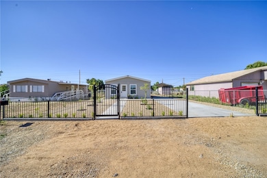View of front of house with a gate and driveway