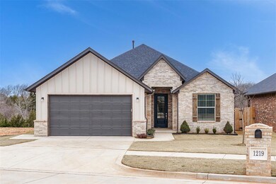 View of front of home with an attached garage, con