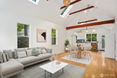 Welcome to this light-filled, open-concept main living space graced maple wood floors. Virtually staged to show ease of furniture placement.