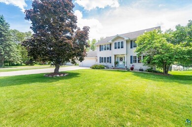 Colonial-style house featuring a front lawn