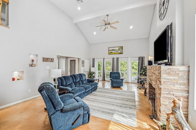 Spacious living room features a fireplace, high ce