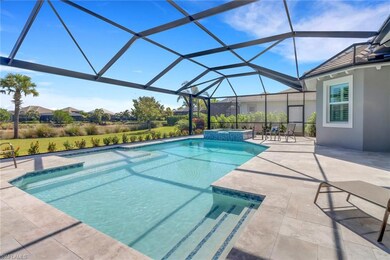 View of pool featuring a patio area, a pool with connected hot tub, and glass enclosure