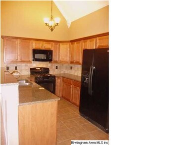 Great kitchen with nice black appliances, tile bac