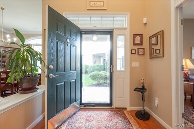 Foyer entrance featuring a chandelier and wood-typ