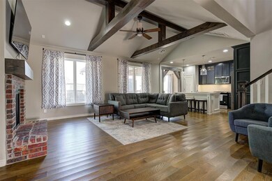 Living room with beamed ceiling, dark hardwood / w