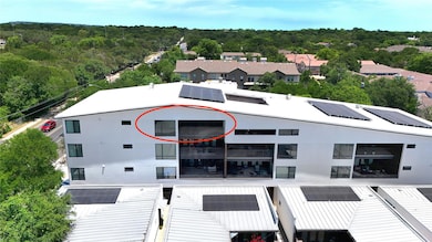 View of building exterior featuring a wooded view