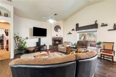 Living room with ceiling fan, dark wood-type floor