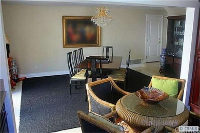 View from kitchen to dining room.  Sliding glass door on left leading to side yard.  Door leads to attached 2 car garage.