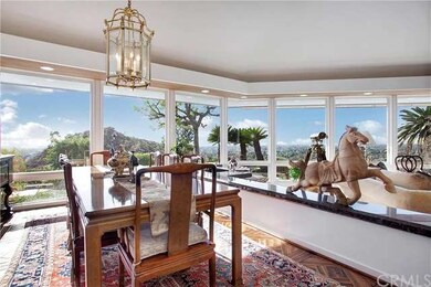Formal dining room, walls of windows with view of 