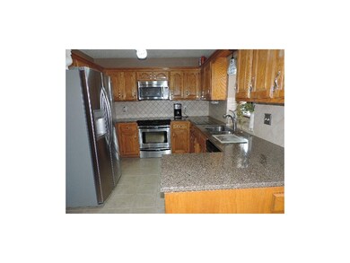 Kitchen area with tile floors, granite countertops