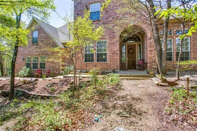 Walkway to front door is beautifully landscaped wi