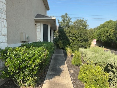 Entrance to property with stucco siding and stone