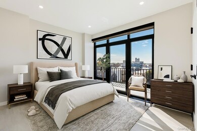 Bedroom featuring recessed lighting, access to outside, light wood finished floors, and a view of city