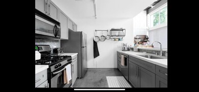 Kitchen featuring backsplash, stainless steel app