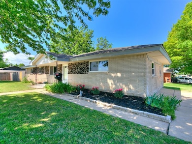 Single story home featuring brick siding and a fro