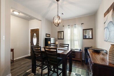 A covered front porch and solid wood front door with decorative beveled glass welcomes you inside, where you will be greeted by elegant wood-look floors, and a lovely formal dining room.