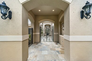 Under the arched entryway are double wrought-iron
