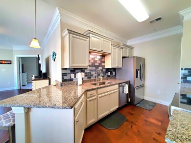 Kitchen featuring dark wood-type flooring, sink, c