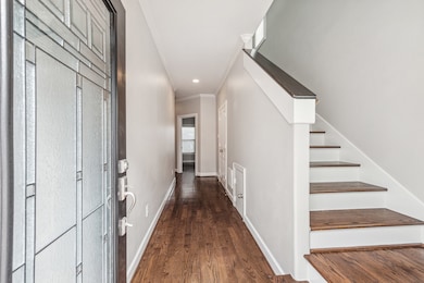 Elegant glass entry & hardwoods throughout