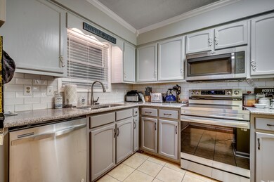 Kitchen with sink, tasteful backsplash, crown mold