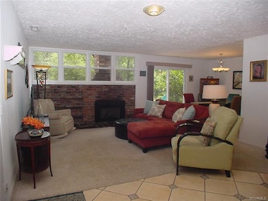Living room has gas log insert. Wood storage area 