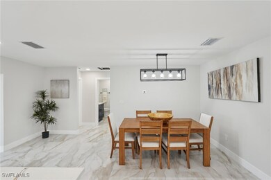 Dining area featuring light marble finish flooring