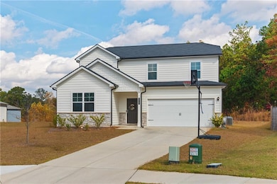 Expansive driveway and two-car garage with refined detailing.
