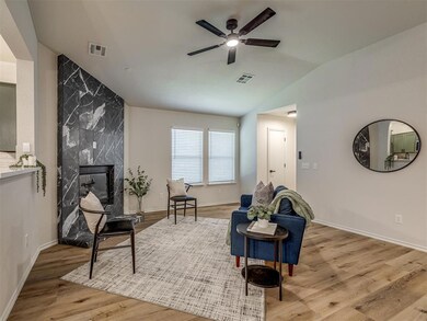 Living area with vaulted ceiling, light hardwood /