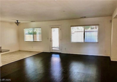 Foyer entrance with wood finished floors and baseb