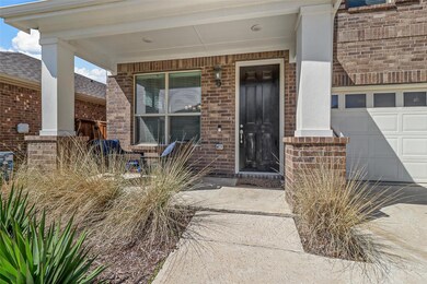 Property entrance featuring covered porch and a garage