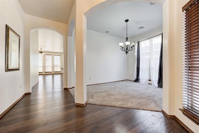 Unfurnished dining area featuring arched walkways,