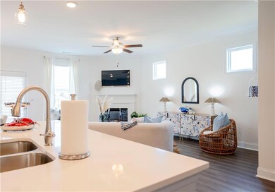 Kitchen with ceiling fan, a glass covered fireplac