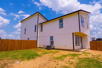 Rear view of property with a fenced backyard