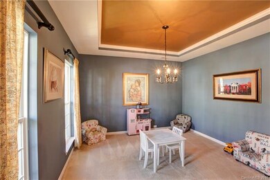 Front room has MANY options!  The sellers use it as a playroom.  It could also be used as a formal dining room or a great front office!