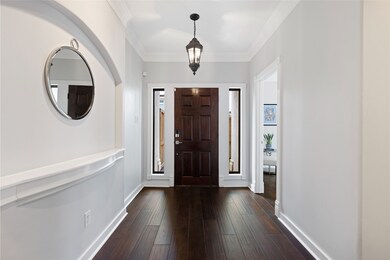 A welcoming entryway features a rich wooden door o