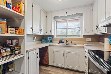 Open style pantry. Space for dishwasher is plumbed if you want one.