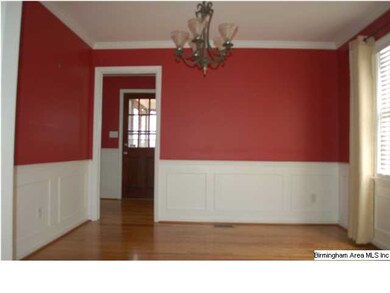 Formal dining room with hardwood floors, wainscoat