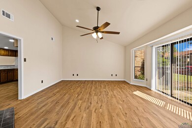 Empty room with ceiling fan, light wood-type flooring, visible vents, recessed lighting, and baseboards