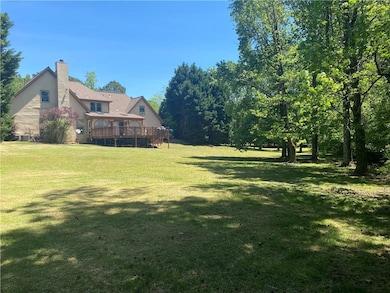 View of grassy yard with a wooden deck