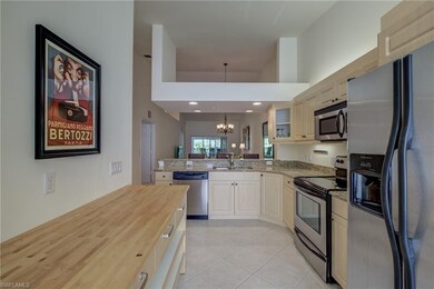 Kitchen features granite counters, light woodgrain