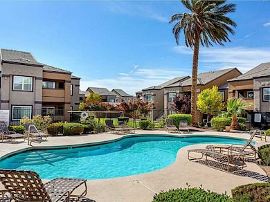 Community pool with a residential view, fence, and