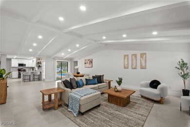 Living room with recessed lighting and concrete fl