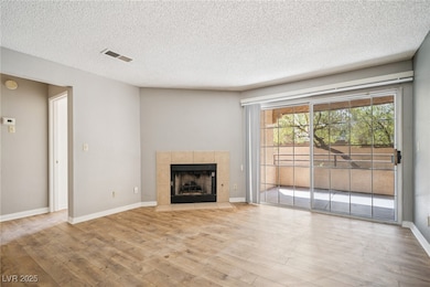 Unfurnished living room featuring wood finished fl