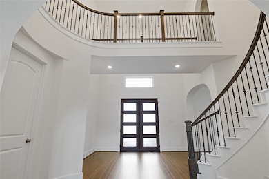 Spacious entryway with high ceilings, a sleek dark