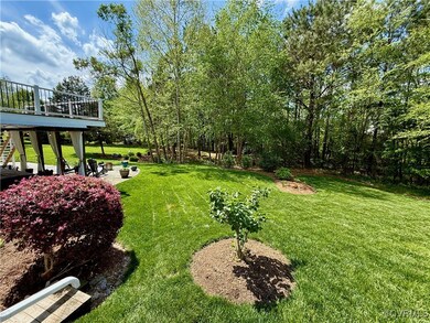 View of yard featuring stairway, a wooden deck, an