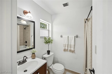 Full bathroom with vanity, toilet, and walk-in sho