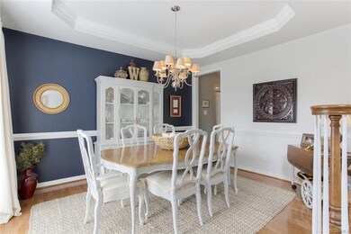 Dining Room with tray ceiling and large picture wi
